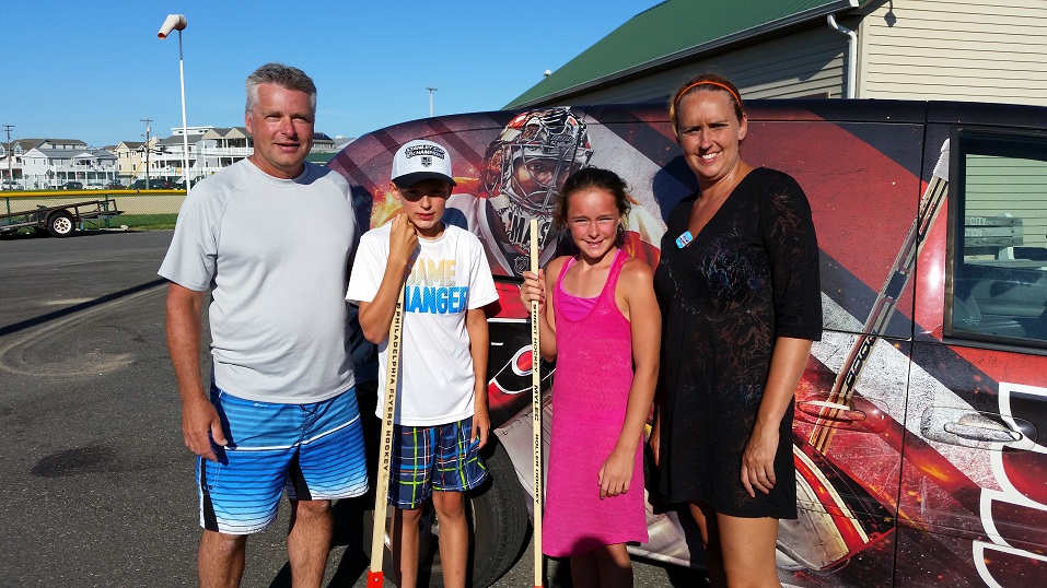 Jean-Francois and Nancy Bisson, vacationers from Quebec City, Canada, watched their 13-year-old son, Philippe, and 12-year-old daughter, Emilie, play at Dealy Field's hockey rink.