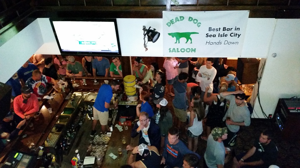 The downstairs bar at the Dead Dog Saloon on Landis Avenue was crowded Saturday afternoon. Bars and nightclubs planned to stay open through the weekend.