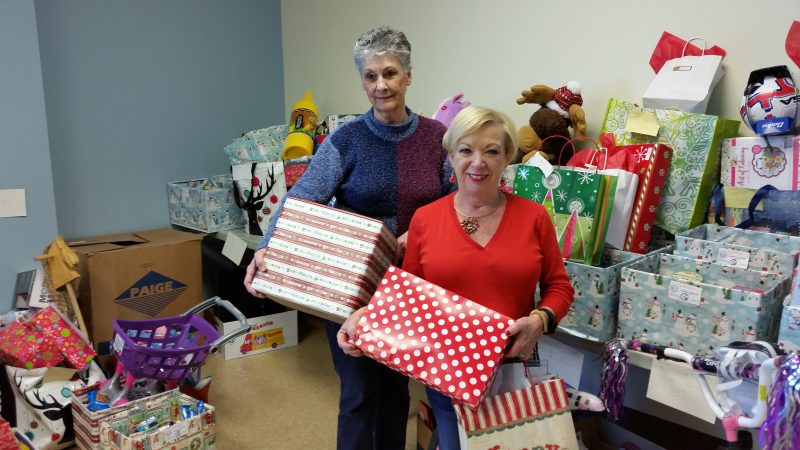 Volunteer Sis Borden, left, and Pattiann Ponichtera, assistant to the mayor, played key roles in the toy and food drive.