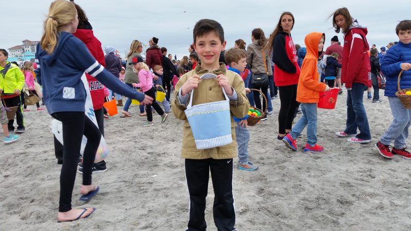 Jake Martino, 7, of Hammonton, holds up the basket of eggs he scooped off the beach.